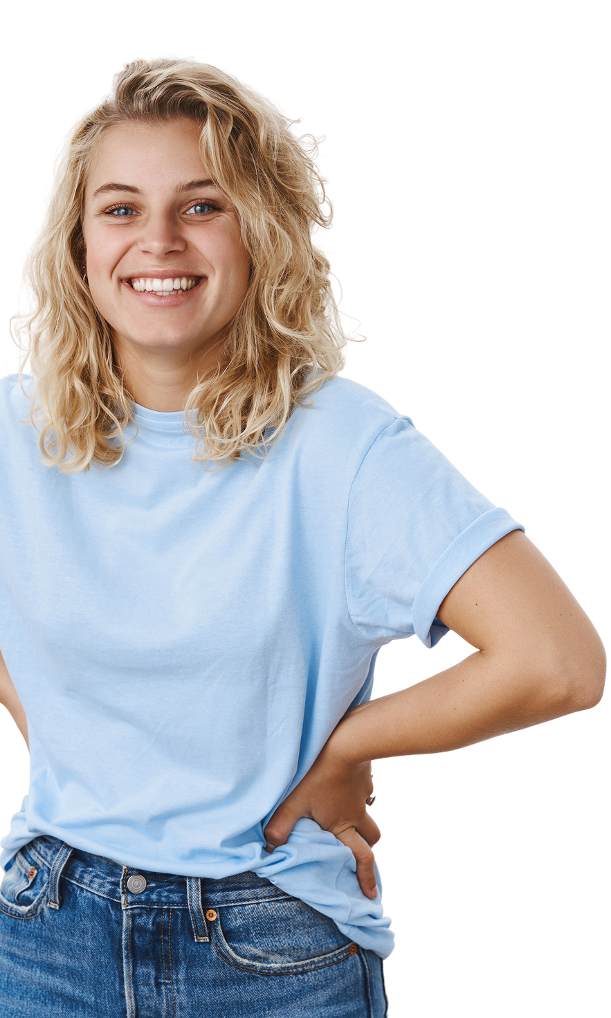 A person in a light blue t-shirt smiling with one hand on her hip